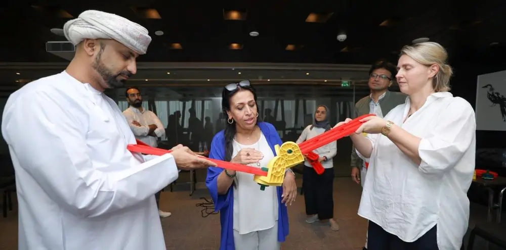 Participants engaged in a team-building activity, enhancing communication, trust, and collaboration.