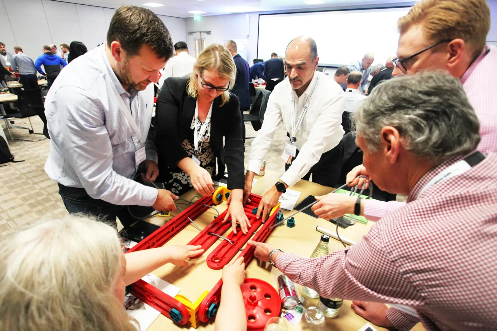 Participants using MTa Insights Kit at a Masterclass, engaging in 'Hoist' activity to develop leadership, instruction, and motivation skills.