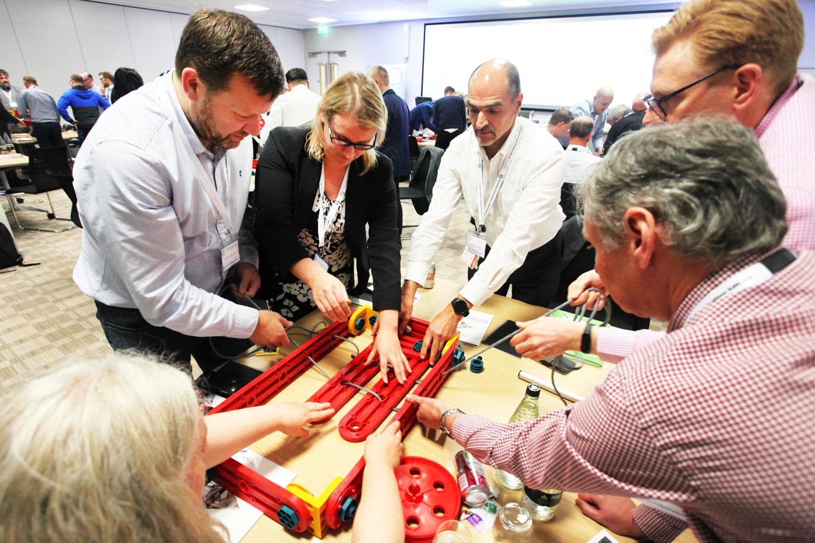 Team members using the MTa Insights Kit to engage in leadership development activities, fostering communication, problem-solving, and self-awareness in an experiential setting.