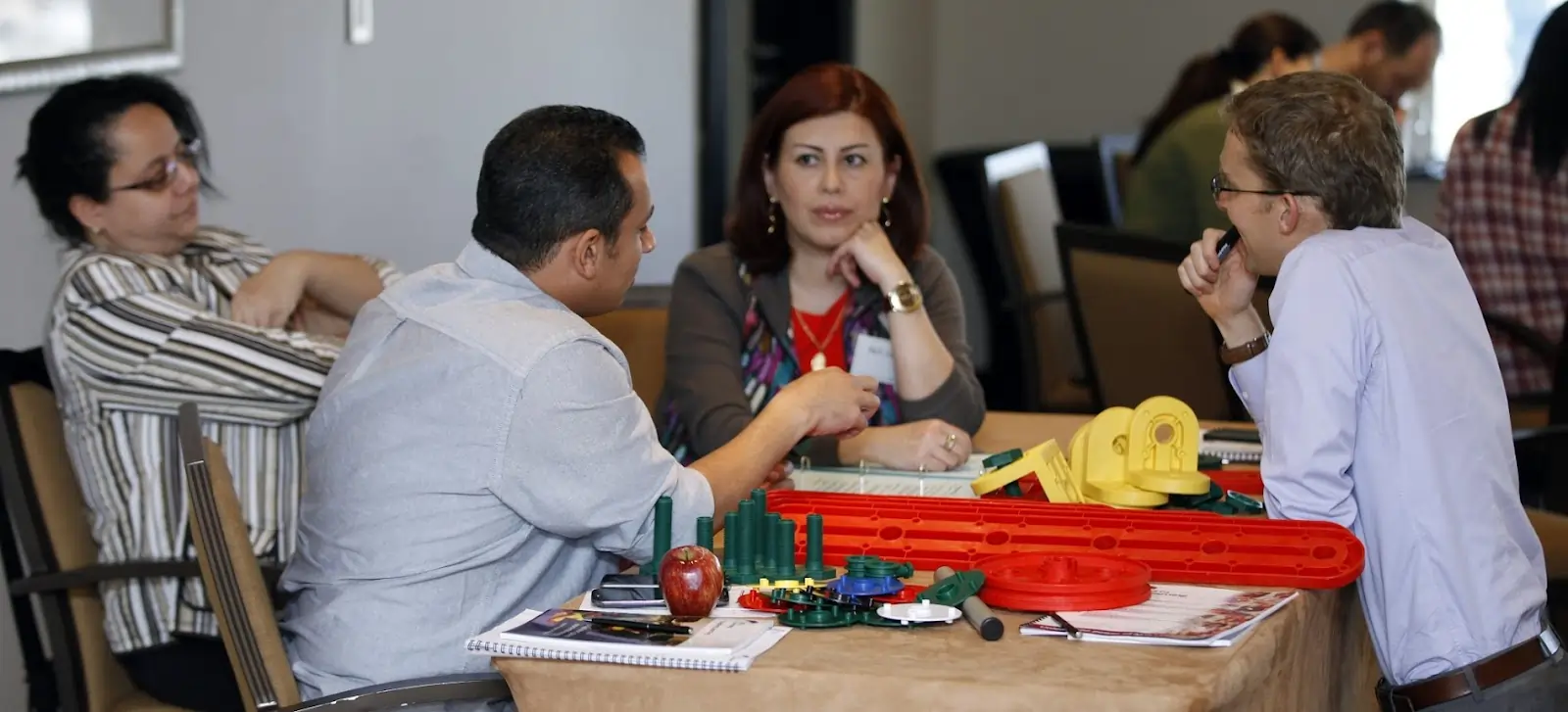 Group discussing the MTa Insights kit, collaborating to identify the right activity for their needs.