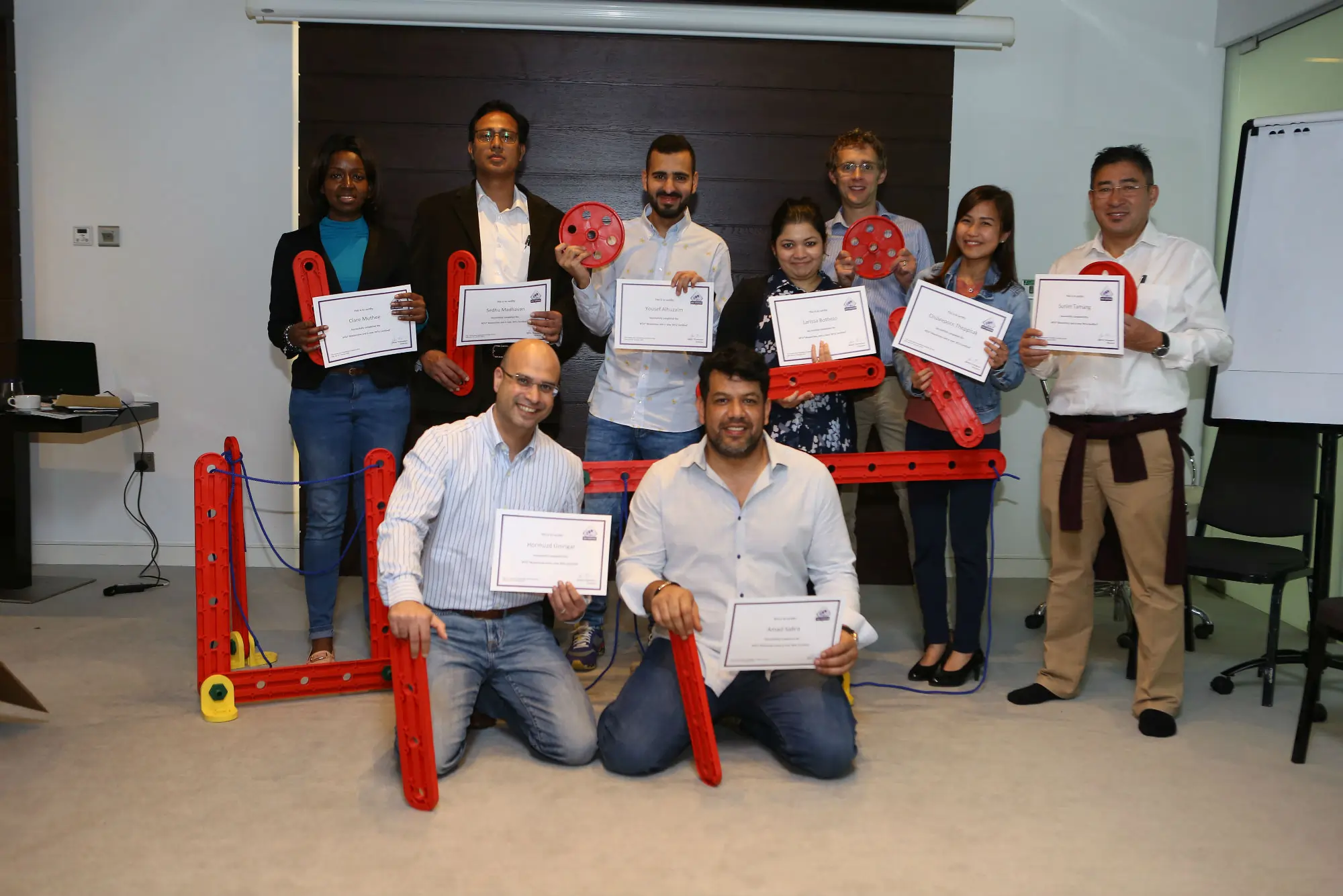 Participants proudly receiving facilitation certificates after completing an MTa masterclass.