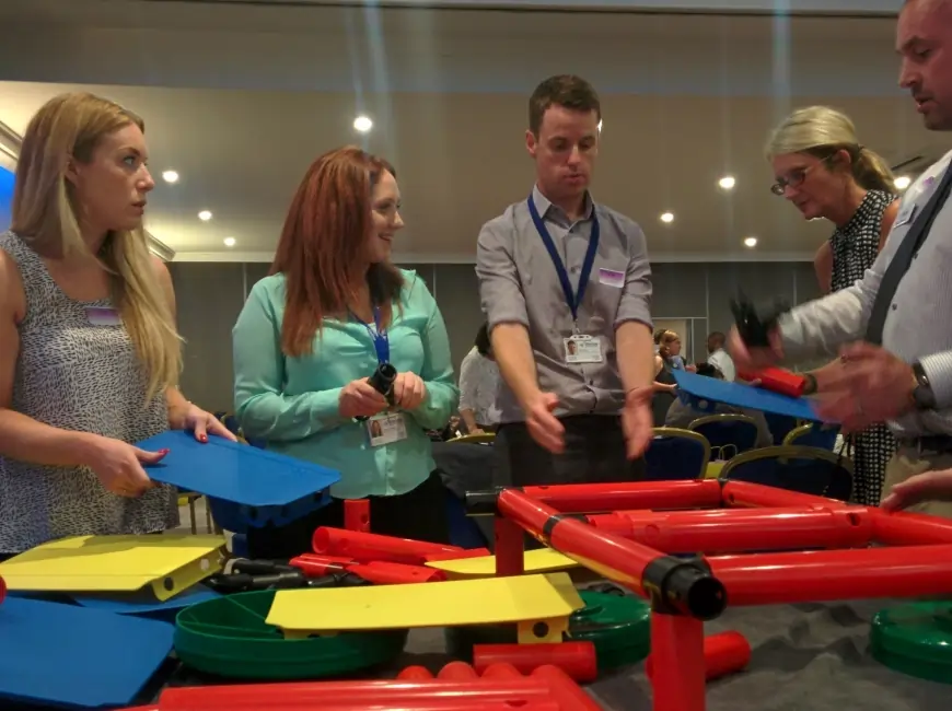 Employees engaging in team-building activities with MTa Kits to improve communication and collaboration.