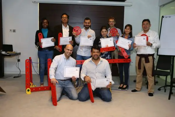 Participants proudly holding certificates after completing the MTa Masterclass on facilitation skills.