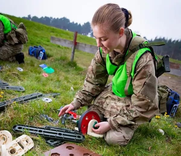 A cadet builds and tests a catapult using the MTa STEM Kit, exploring trajectories and energy.